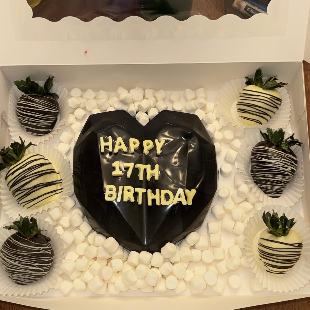 Black glossy breakable heart with HAPPY 17TH BIRTHDAY in white letters, surrounded by alternating dark and white chocolate drizzled strawberries.