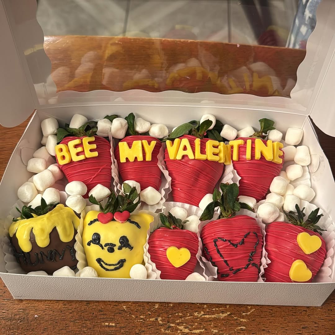 Bee My Valentine themed strawberries in red and yellow with BEE MY VALENTINE letters, a honey pot design, and a bee-face strawberry with heart accents.